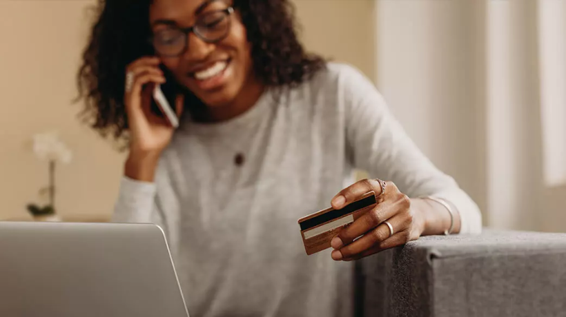 Woman paying by card over phone